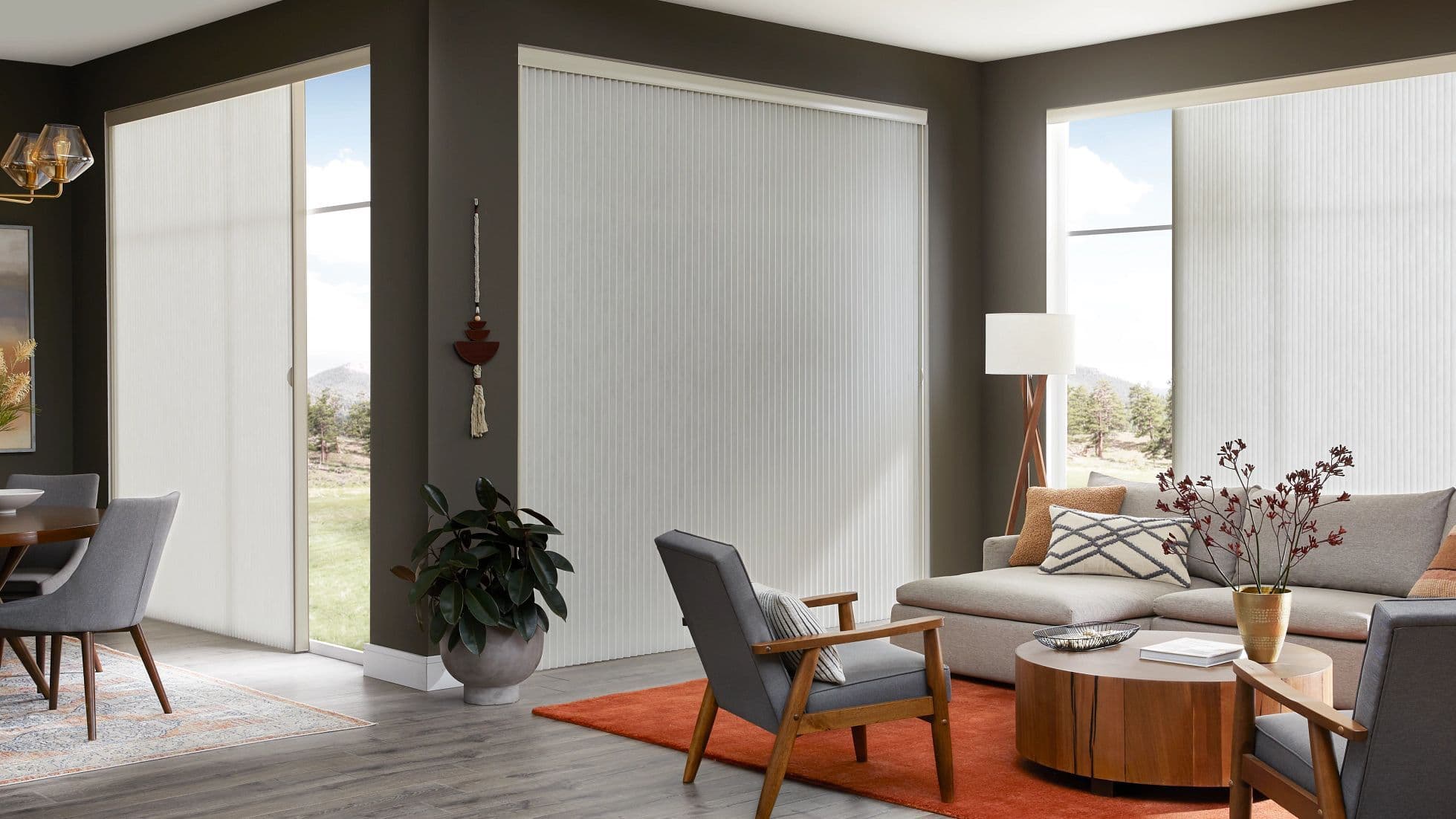 Cellular shades covering tall windows and a wide patio door